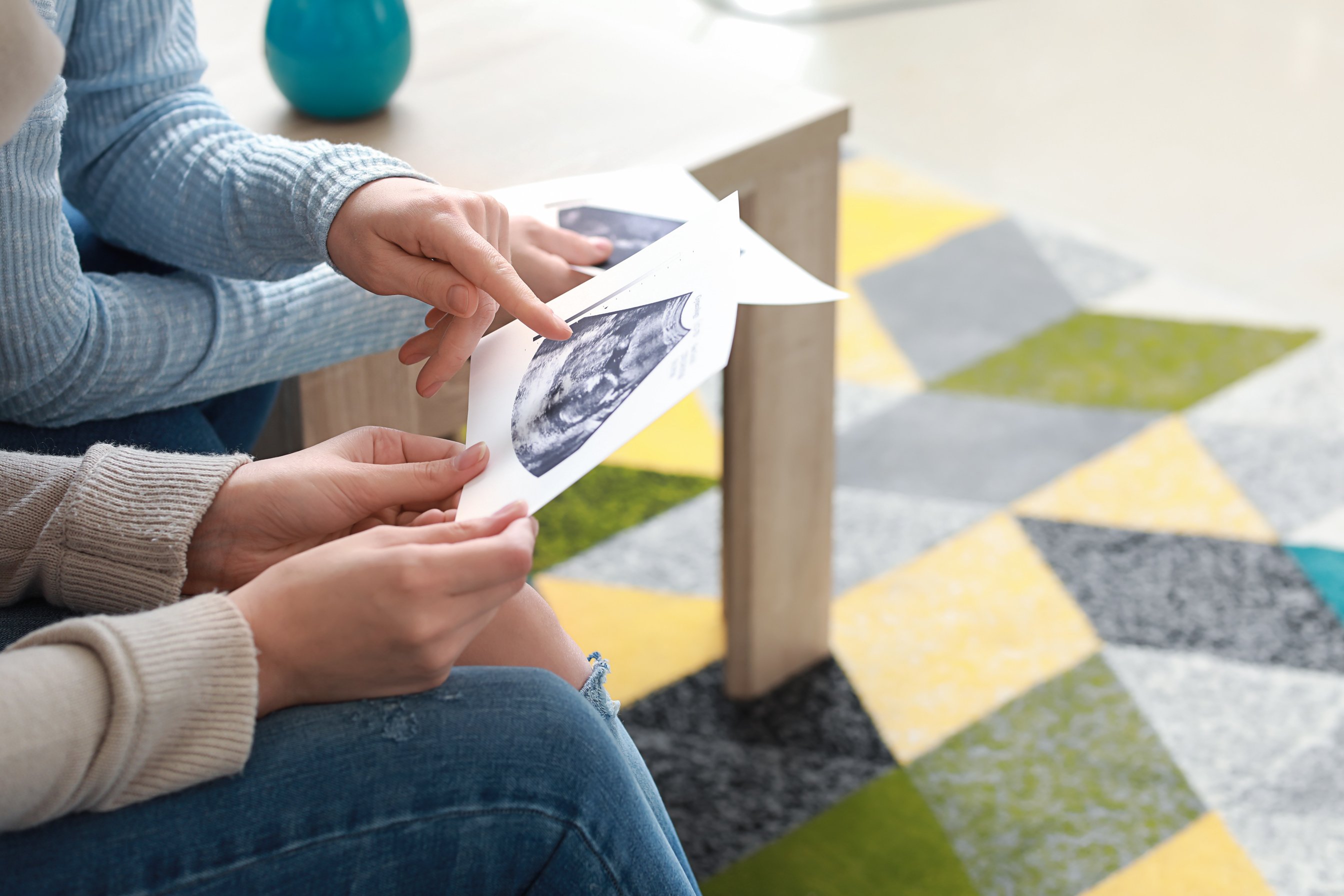 Doula and Pregnant Woman with Ultrasound Scans at Home